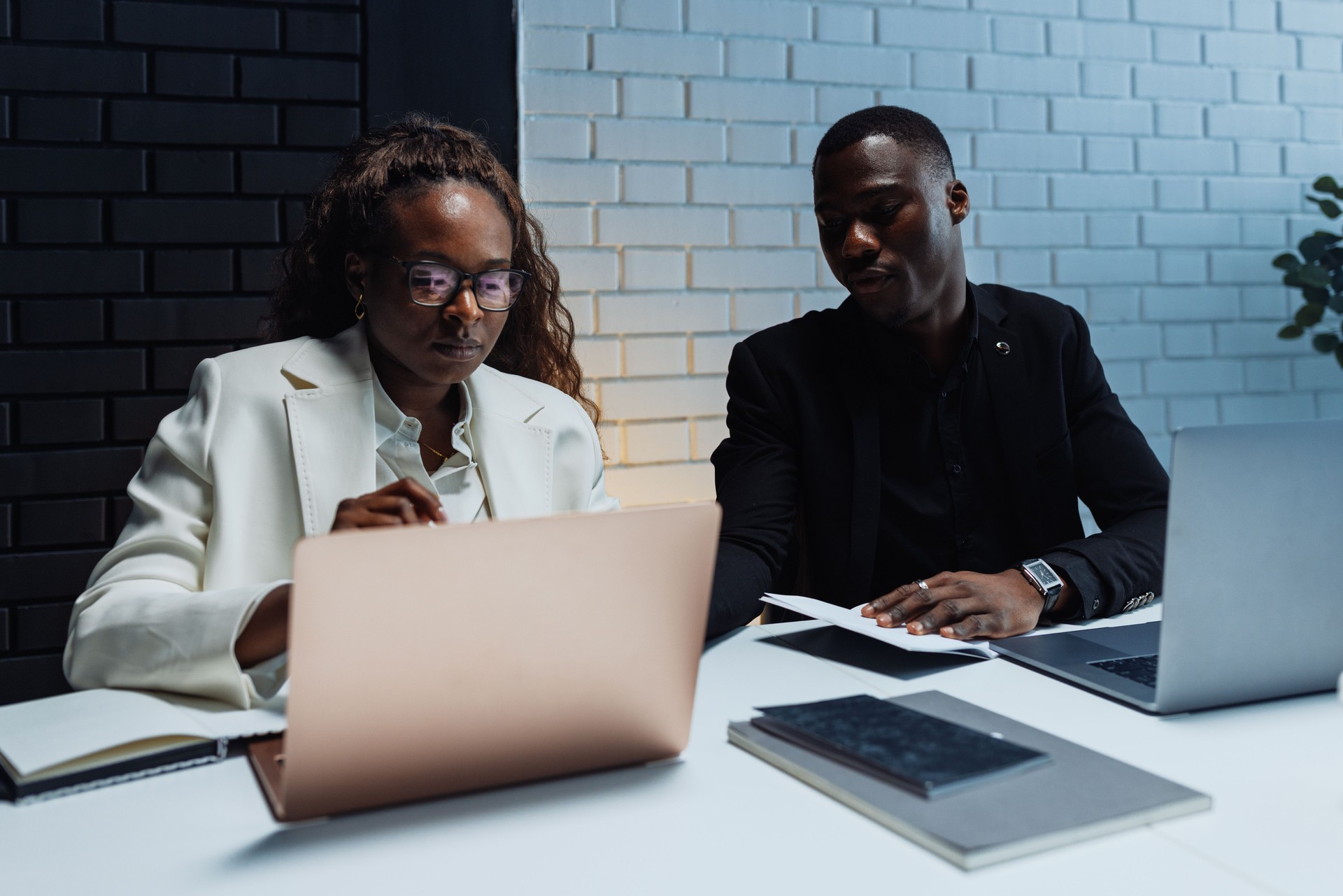 Focused business partners working together on a project using laptop