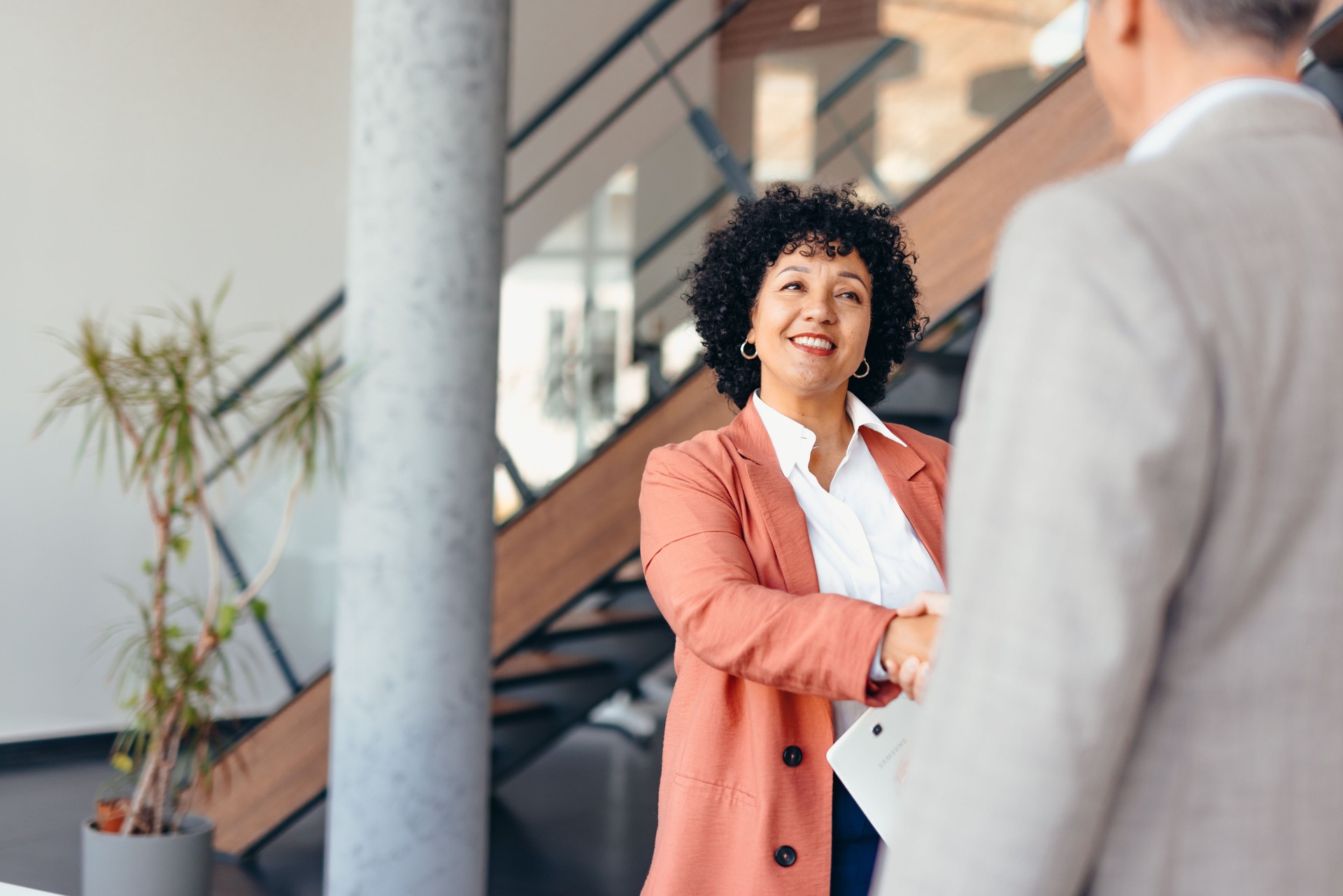 Confident Businesswoman Smiling During a Professional Handshake